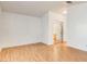 Spacious bedroom with wood flooring, sliding closet doors, and attached bathroom at 3673 Ian Thomas St # 201, Las Vegas, NV 89129