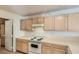 Functional kitchen featuring white appliances, ample counter space, and light wood cabinets at 3673 Ian Thomas St # 201, Las Vegas, NV 89129