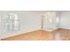 Bright living room featuring wood flooring, large arched windows, and ample space for modern living at 3673 Ian Thomas St # 201, Las Vegas, NV 89129