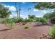Fully landscaped backyard with pool, fire pit with chairs, mature trees, and an outdoor dining area at 3681 S Rosecrest Cir, Las Vegas, NV 89121