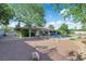 Gorgeous landscaped backyard with pool, covered patio, fire pit area, and mature trees at 3681 S Rosecrest Cir, Las Vegas, NV 89121