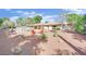 Expansive backyard featuring desert landscaping, outdoor seating area, and partial pool view at 3681 S Rosecrest Cir, Las Vegas, NV 89121