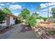 A relaxing backyard, featuring a stone-paved walkway and multiple seating areas at 3681 S Rosecrest Cir, Las Vegas, NV 89121