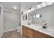 Bathroom featuring dual sinks, white cabinets, and a walk-in shower at 3681 S Rosecrest Cir, Las Vegas, NV 89121