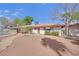 Back of the home with low maintenance desert rock landscaping, covered patio, and attached pool at 3681 S Rosecrest Cir, Las Vegas, NV 89121