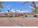 Inviting single-story home with well-maintained landscaping and a decorative rock feature leading to the front entrance at 3681 S Rosecrest Cir, Las Vegas, NV 89121