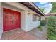 Home featuring red double doors, exterior light, and manicured landscape at 3681 S Rosecrest Cir, Las Vegas, NV 89121