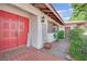 Close-up of the elegant red front door with textured detailing and charming welcome decor at 3681 S Rosecrest Cir, Las Vegas, NV 89121