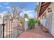 Attractive wrought iron gate and desert-style landscaping accentuating the home's facade and walkway at 3681 S Rosecrest Cir, Las Vegas, NV 89121