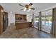 Eat-in kitchen with tile floors, kitchen island, wood cabinets, and sliding doors to backyard at 3681 S Rosecrest Cir, Las Vegas, NV 89121