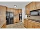 Kitchen showcasing stainless steel appliances, granite countertops, and a tile floor at 3681 S Rosecrest Cir, Las Vegas, NV 89121