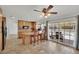 Bright eat-in kitchen features a center island with barstool seating and direct access to the backyard pool at 3681 S Rosecrest Cir, Las Vegas, NV 89121