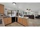 Open kitchen with island, granite countertops, tile floor and stainless steel appliances at 3681 S Rosecrest Cir, Las Vegas, NV 89121