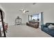 Spacious living room with neutral carpet, a large window offering natural light, and a cozy seating area at 3681 S Rosecrest Cir, Las Vegas, NV 89121