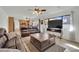 Open-concept living room features backyard views, comfortable seating, and flows into the kitchen and dining at 3681 S Rosecrest Cir, Las Vegas, NV 89121