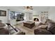 Relaxing living room showcases a cozy fireplace, built-in shelving, a ceiling fan, and ample seating at 3681 S Rosecrest Cir, Las Vegas, NV 89121