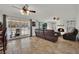 Spacious living room with a cozy fireplace and backyard views, seamlessly connecting to the outdoor pool area at 3681 S Rosecrest Cir, Las Vegas, NV 89121