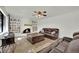 Cozy living room has a white brick fireplace, built-in shelving, and comfortable seating near a window at 3681 S Rosecrest Cir, Las Vegas, NV 89121