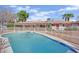 Beautiful pool with fencing, complimented by desert landscaping and rock at 3681 S Rosecrest Cir, Las Vegas, NV 89121
