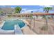 Sparkling pool featuring diving board and secure fencing, with a desert rock landscape at 3681 S Rosecrest Cir, Las Vegas, NV 89121