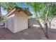 An outdoor storage shed sits on a gravel area in the backyard of this residence at 3681 S Rosecrest Cir, Las Vegas, NV 89121