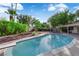 A blue swimming pool with diving board is surrounded by a landscaped backyard at 3681 S Rosecrest Cir, Las Vegas, NV 89121