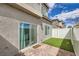 A cozy backyard showcases artificial turf, brick pavers, and white fencing at 3693 Canis Minor Ln # 13101, Henderson, NV 89052