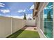 A private backyard is fenced in and has artificial turf and brick pavers at 3693 Canis Minor Ln # 13101, Henderson, NV 89052
