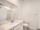 Contemporary bathroom featuring a single sink vanity, toilet and shower with white tile surround at 3693 Canis Minor Ln # 13101, Henderson, NV 89052