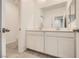This bathroom has a double sink vanity, tile floor and modern fixtures at 3693 Canis Minor Ln # 13101, Henderson, NV 89052