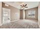 Bedroom featuring neutral paint, plush carpet, a ceiling fan and a window with mountain views at 3693 Canis Minor Ln # 13101, Henderson, NV 89052