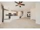 Open-concept living area features a staircase, chandelier and sleek modern kitchen at 3693 Canis Minor Ln # 13101, Henderson, NV 89052