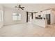 Bright living room boasts neutral tile flooring, a ceiling fan, and access to the patio at 3693 Canis Minor Ln # 13101, Henderson, NV 89052