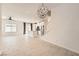 Spacious living room with a kitchen and chandelier lighting fixtures at 3693 Canis Minor Ln # 13101, Henderson, NV 89052