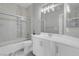 Bathroom offers a shower-tub combo with white vanity and granite countertop at 3975 N Hualapai Way # 235, Las Vegas, NV 89129