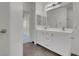 Bright bathroom features a double sink vanity with white cabinets and a large mirror at 3975 N Hualapai Way # 235, Las Vegas, NV 89129