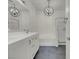 Bright bathroom featuring double sink vanity, bathtub, shower, and modern fixtures at 3975 N Hualapai Way # 235, Las Vegas, NV 89129