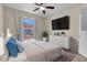 Cozy bedroom with a large window, ceiling fan, and a television on the wall at 3975 N Hualapai Way # 235, Las Vegas, NV 89129