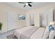Bright bedroom featuring carpeted floors, ceiling fan, en-suite bathroom, and walk-in closet at 3975 N Hualapai Way # 235, Las Vegas, NV 89129