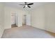 Neutral bedroom with carpeted floors, ceiling fan, adjoining walk-in closet and bathroom at 3975 N Hualapai Way # 235, Las Vegas, NV 89129