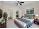 This bedroom features neutral walls, carpeted floors, ceiling fan and stylish modern furnishings at 3975 N Hualapai Way # 235, Las Vegas, NV 89129