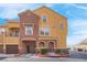 Stucco house featuring a two car garage, arched entryway, and desert landscaping at 3975 N Hualapai Way # 235, Las Vegas, NV 89129
