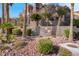 A picturesque building featuring lush landscaping and serene desert surroundings at 3975 N Hualapai Way # 235, Las Vegas, NV 89129