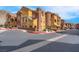 Multi-colored townhome complex features stucco exterior and tile roof at 3975 N Hualapai Way # 235, Las Vegas, NV 89129
