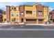 Exterior view of home with two car garage, stucco siding, and desert landscaping at 3975 N Hualapai Way # 235, Las Vegas, NV 89129