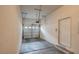 Well-lit garage with a white door and convenient access to the home at 3975 N Hualapai Way # 235, Las Vegas, NV 89129