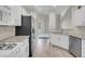 Galley kitchen with stainless appliances, white cabinets, and granite countertops at 3975 N Hualapai Way # 235, Las Vegas, NV 89129