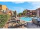 Inviting community pool with lounge chairs and well-manicured landscaping, perfect for relaxation and enjoyment at 3975 N Hualapai Way # 235, Las Vegas, NV 89129