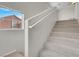 Bright staircase features neutral carpet and leads to the upper level, adjacent to a window at 3975 N Hualapai Way # 235, Las Vegas, NV 89129