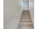 Carpeted stairs with white railing leading up to a bright, window-lit space at 3975 N Hualapai Way # 235, Las Vegas, NV 89129